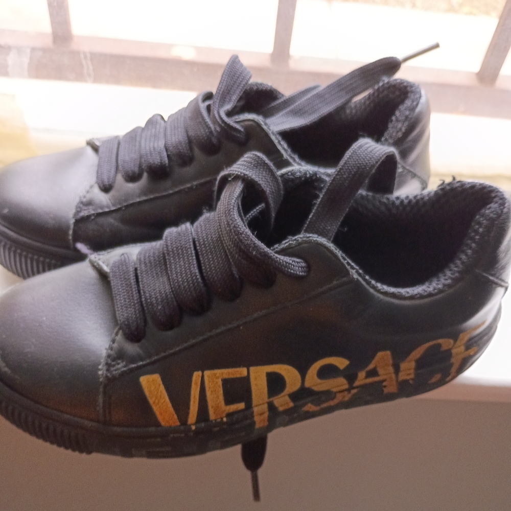 Versace Kids Black and The sole is slightly scratched but otherwise fine.